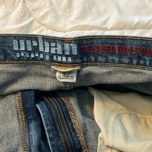 Men’s Urban Outfitters Blue Bootcut Jeans with Distressed Details.